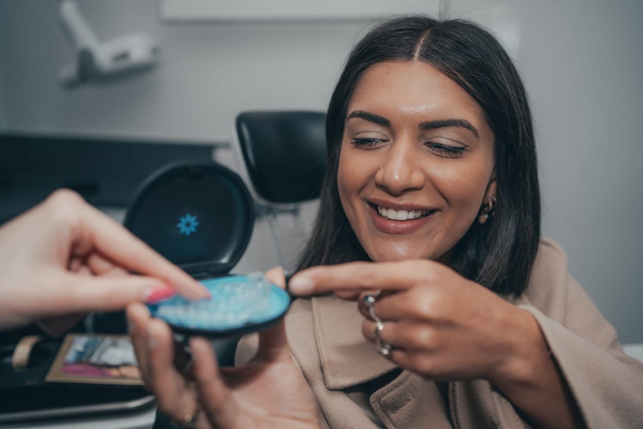 Dentist showing an Invisalign treatment simulation to a patient at Mortiboys Dental Spa, East Horsley