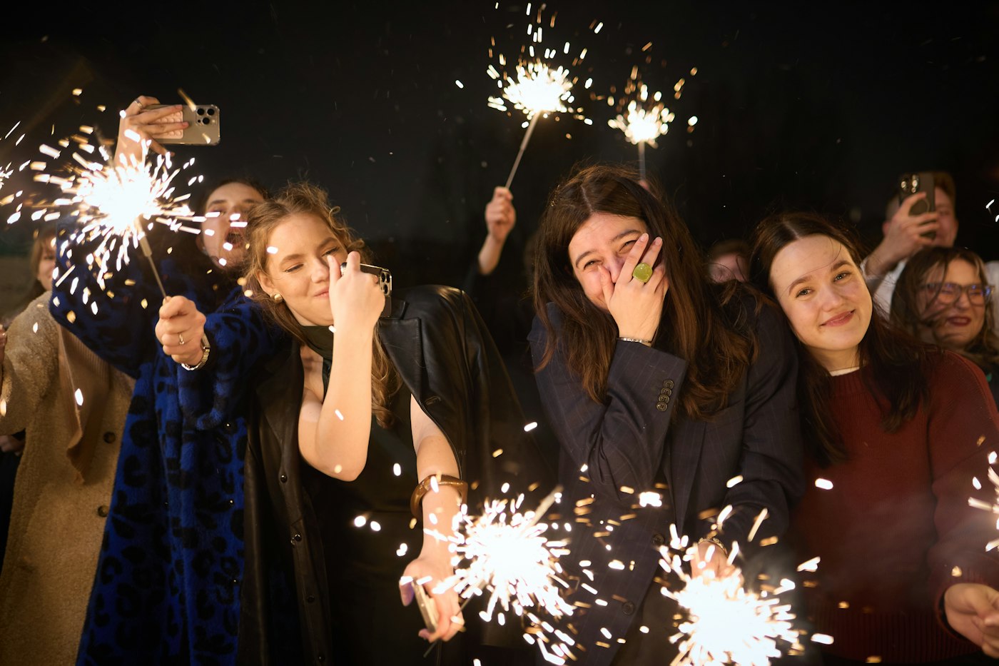 Friends celebrating New Year with sparklers